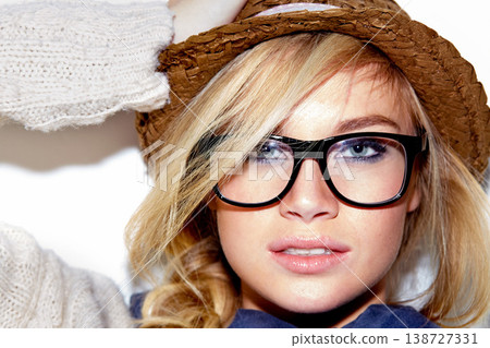 Portrait, fashion or beauty with a woman in glasses and a hat closeup in studio on a white background. Face, makeup and accessories with a confident young blonde person in trendy eyewear for vision 138727331