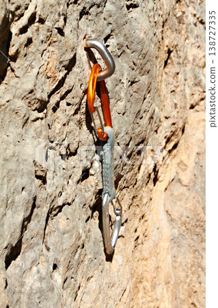 Rock, climbing and carabiner tools on mountain, boulder or cliff for safety in exercise. Metal, gear and secure bolt on rocks with outdoor training and adventure in nature with danger or risk Rock, climbing and carabiner tools on mountain, boulder or cliff for safety in exercise. Metal, gear and secure bolt on rocks with outdoor training and adventure in nature with danger or risk 138727335