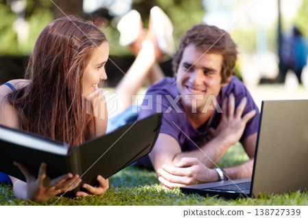 Students, outdoor and laptop on grass, university and smile for workbook, learning and technology. College, notebook and teenager for education, career or studying together for exam, man and woman Students, outdoor and laptop on grass, university and smile for workbook, learning and technology. College, notebook and teenager for education, career or studying together for exam, man and woman 138727339