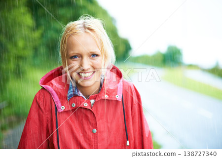 Woman, smile and raincoat in outdoor weather, wet and cold from rain, winter and nature. Happy female person, fashion and red jacket is stylish, rainfall and protection from water, face and portrait Woman, smile and raincoat in outdoor weather, wet and cold from rain, winter and nature. Happy female person, fashion and red jacket is stylish, rainfall and protection from water, face and portrait 138727340