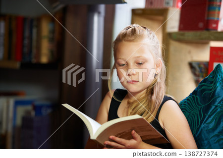 Girl, kid and library for reading book, education and learning of language, literature and fiction story on sofa. Child relax in bookstore with novel for creative development, knowledge and school Girl, kid and library for reading book, education and learning of language, literature and fiction story on sofa. Child relax in bookstore with novel for creative development, knowledge and school 138727374