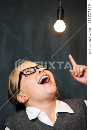Student, child and lightbulb for solution, learning and wow, surprise or excited for future, ideas and knowledge in school. Girl kid thinking with light bulb, glow and black chalkboard for vision Student, child and lightbulb for solution, learning and wow, surprise or excited for future, ideas and knowledge in school. Girl kid thinking with light bulb, glow and black chalkboard for vision 138727399