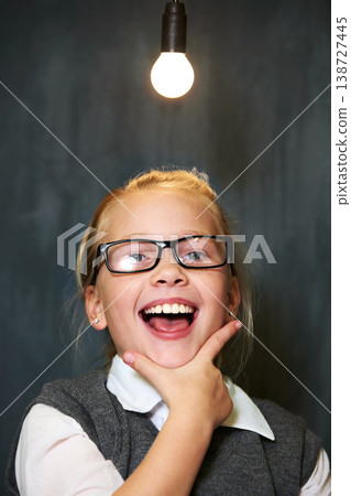 Student portrait, girl and lightbulb for solution, learning and wow, surprise or excited for future, ideas and knowledge in school. Child or kid with light bulb, emoji and black chalkboard for vision Student portrait, girl and lightbulb for solution, learning and wow, surprise or excited for future, ideas and knowledge in school. Child or kid with light bulb, emoji and black chalkboard for vision 138727445