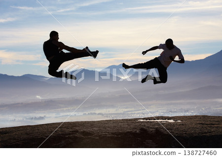 Flying, kick and karate men on mountain top for fitness, training or body, speed or power on sky background. Martial arts, taekwondo or MMA friends in nature with jump, fighting or sports exercise Flying, kick and karate men on mountain top for fitness, training or body, speed or power on sky background. Martial arts, taekwondo or MMA friends in nature with jump, fighting or sports exercise 138727460