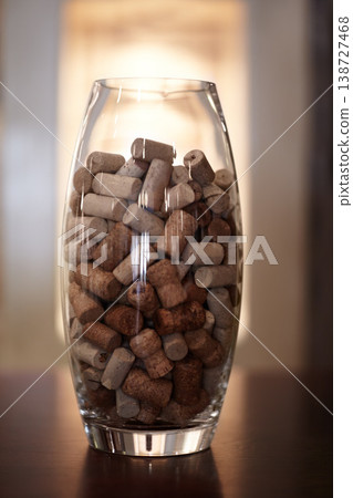 Winery, glass and jar with a group of cork plugs on a wooden table closeup for decoration or preservation. Background, texture and interior design with stopper seals in a vase for sustainability Winery, glass and jar with a group of cork plugs on a wooden table closeup for decoration or preservation. Background, texture and interior design with stopper seals in a vase for sustainability 138727468