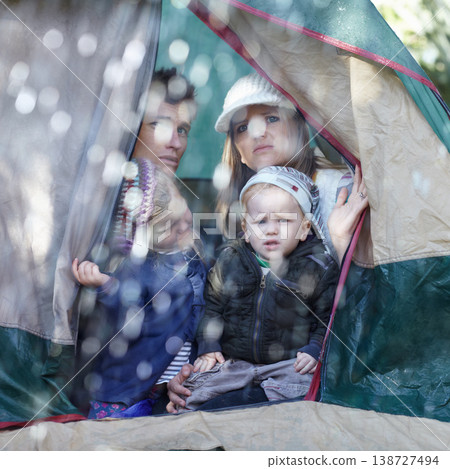 Camping, family and parents with children in rain sad for adventure, holiday and vacation in winter outdoors. Disappointed, unhappy and mother, father and kids in tent with bad weather for travel 138727494