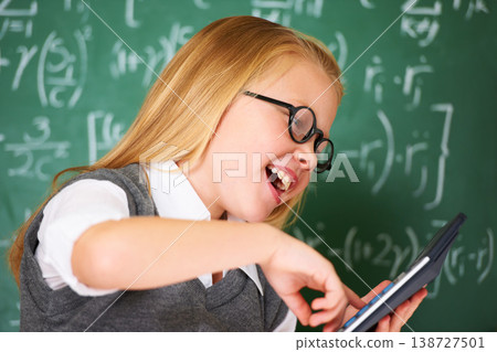 child, student and calculator by chalkboard for happy education, learning and problem solving or solution. Smart girl or child with glasses and excited for school, typing numbers or math in classroom child, student and calculator by chalkboard for happy education, learning and problem solving or solution. Smart girl or child with glasses and excited for school, typing numbers or math in classroom 138727501