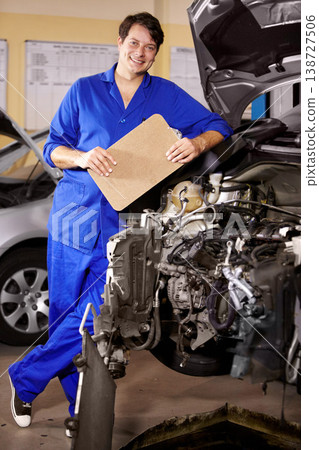 Portrait, happy man and technician with checklist on engine of car, repair or maintenance. Smile, mechanic and person with clipboard on motor hood, auto service and workshop, garage or small business 138727506