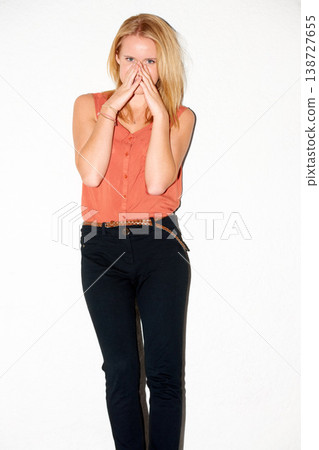 Fashion, confidence and portrait of woman on a white background with pride, natural beauty and smile. Relax, hands on face and isolated person in trendy clothes, casual outfit and style in studio 138727655