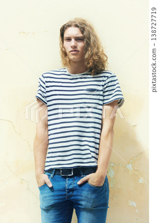 College student, fashion and portrait on wall outdoor with casual, style or outfit on background. Man, relax and streetwear for university, campus and jeans with tshirt in urban city on weekend College student, fashion and portrait on wall outdoor with casual, style or outfit on background. Man, relax and streetwear for university, campus and jeans with tshirt in urban city on weekend 138727719