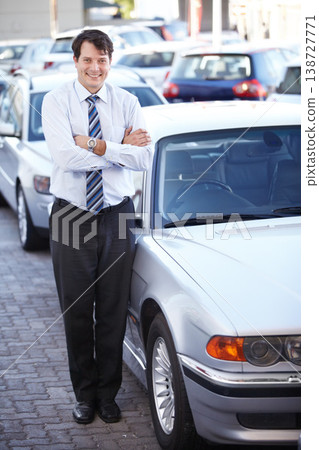 Portrait, lease and a man arms crossed at a dealership for car sale in a commercial parking lot. Business, rental and automobile trade with a happy young salesman outdoor for transport service Portrait, lease and a man arms crossed at a dealership for car sale in a commercial parking lot. Business, rental and automobile trade with a happy young salesman outdoor for transport service 138727771