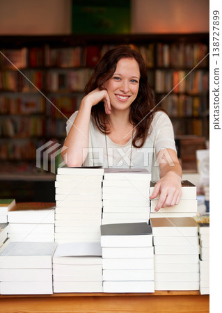 Woman, bookshop business owner and smile in portrait by stack for discount, sale or pride for promotion. Entrepreneur, library and happy for retail deal, literature or knowledge for learning in store Woman, bookshop business owner and smile in portrait by stack for discount, sale or pride for promotion. Entrepreneur, library and happy for retail deal, literature or knowledge for learning in store 138727899