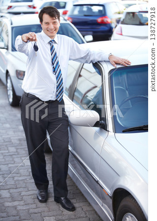 Businessman, portrait and key in hand to car with sale of auto, transportation and investment. Vehicle, dealership or man with keys in parking lot from salesman for test drive, opportunity or driving Businessman, portrait and key in hand to car with sale of auto, transportation and investment. Vehicle, dealership or man with keys in parking lot from salesman for test drive, opportunity or driving 138727918