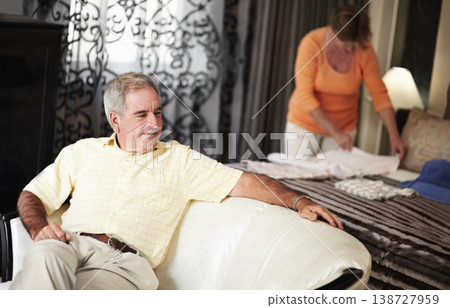 Hotel, senior man and woman packing clothes in bedroom on retirement holiday chat together. Travel, vacation and happy old couple unpacking with bed, sofa and relax with luxury hospitality in room. 138727959