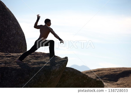 Mountains, kickboxing and man with training, exercise and fresh air with wellness, fighting and nature. Person, athlete and guy with practice, fitness and outdoor with workout, karate and challenge 138728033
