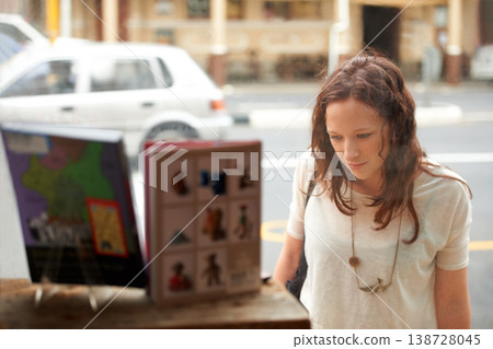 Book store, window shopping and woman with retail sale, discount and customer with choice. City, town and sidewalk with a female person at shop and boutique for purchase, library and glass on road 138728045