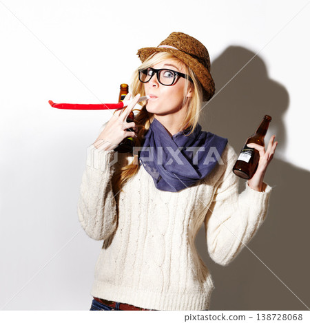 Beer, portrait or woman with party horn for fun celebration, holiday vacation or hipster event in studio. New year, festive or female person drinking alcohol or beverage in bottle on white background 138728068