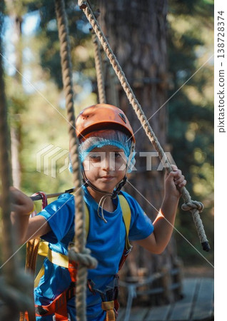 Child Navigating Rope Course at Adventure Park 138728374