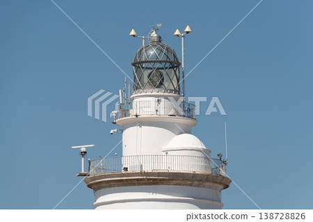 Upper section of La Farola lighthouse with lantern room and railings. Malaga, Spain Upper section of La Farola lighthouse with lantern room and railings. Malaga, Spain 138728826