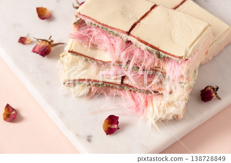 Closeup layered dessert with cotton candy texture and rose decoration 138728849