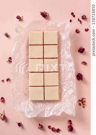 Top view pastel dessert squares with rose petals minimal flat lay composition 138728850
