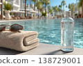 Luxury Poolside Relaxation with Towel, Sunglasses, and Water Bottle for a Tropical Vacation Generative AI 138729001