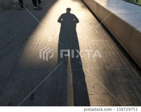 Shadows stretching across the road illuminated by the setting sun Shadows stretching across the road illuminated by the setting sun 138729751