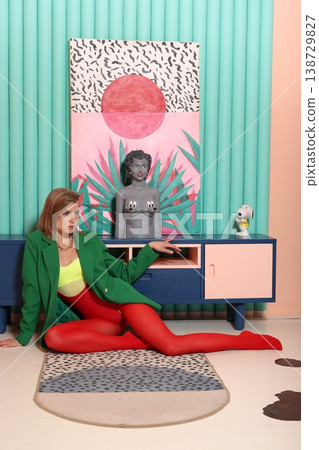 Chic woman lounging on floor amidst modern decorative elements Chic woman lounging on floor amidst modern decorative elements 138729827