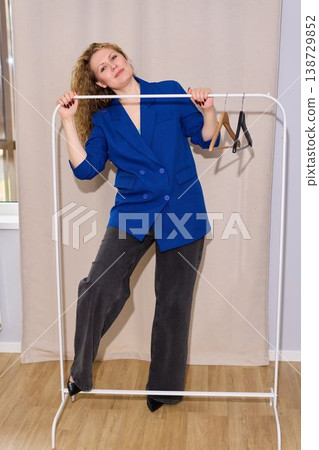 Boutique proprietor reviewing garment organization details Boutique proprietor reviewing garment organization details 138729852
