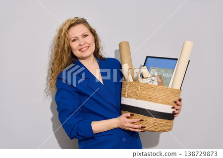 Woman carefully examining architectural drawings and detailed scale model Woman carefully examining architectural drawings and detailed scale model 138729873