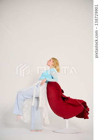 Tranquil woman seated with gentle illumination highlighting details Tranquil woman seated with gentle illumination highlighting details 138729901