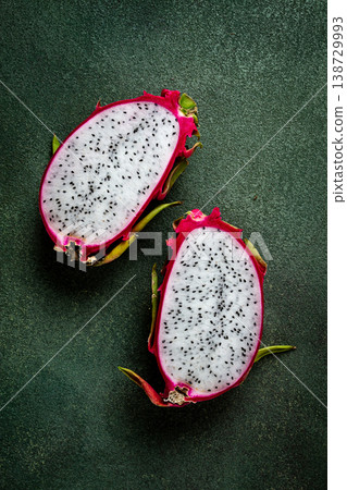 Dragon fruit, pitahaya, one piece, cut, top view, rustic style, green background, Dragon fruit, pitahaya, one piece, cut, top view, rustic style, green background, 138729993