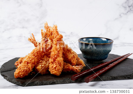 shrimp in tempura, deep fried, on black slate, with sauce, light marble table, no people, shrimp in tempura, deep fried, on black slate, with sauce, light marble table, no people, 138730031