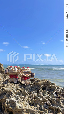 Okinawa's blue sea and a Shisa holding a bottle of Awamori (Okinawan liquor) - Landscape photograph (copy space available) Okinawa's blue sea and a Shisa holding a bottle of Awamori (Okinawan liquor) - Landscape photograph (copy space available) 138730084