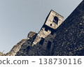 Bell tower and massive castle wall in Cavriana with rugged masonry stark lights film grain mood 138730116