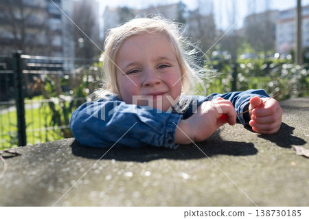 Close up portrait of a lovely 4 year old girl walking outdoors 138730185