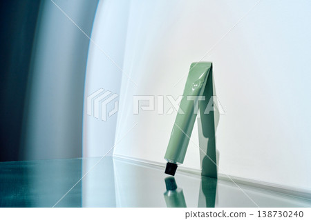 Skincare cosmetic tube reflecting on shiny surface Skincare cosmetic tube reflecting on shiny surface 138730240