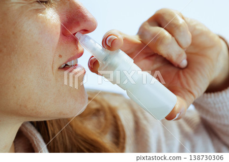Profile of Woman Using Nasal Spray for Sinusitis Profile of Woman Using Nasal Spray for Sinusitis 138730306