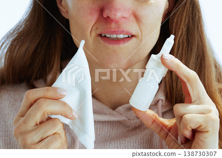 Woman with Tissue and Nasal Spray for Cold Relief Woman with Tissue and Nasal Spray for Cold Relief 138730307