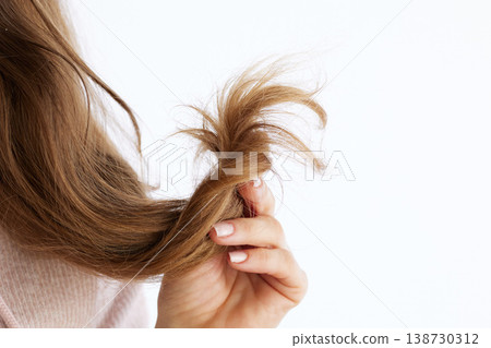 Close-Up of Dry and Frizzy Light Brown Hair Section Close-Up of Dry and Frizzy Light Brown Hair Section 138730312