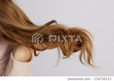 Side Profile of Woman Holding Wavy Hair Texture Side Profile of Woman Holding Wavy Hair Texture 138730315
