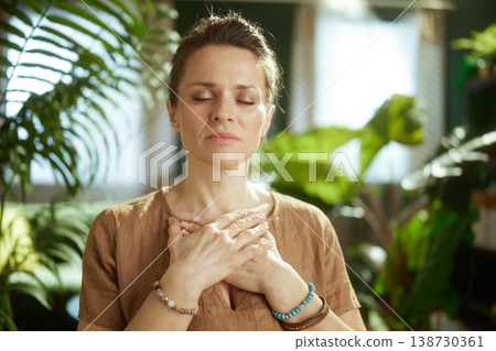 Woman Practicing Heart-Centered Meditation for Mental Clarity 138730361
