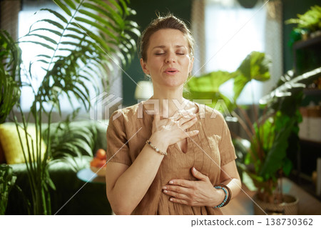 Focused Woman Deeply Breathing for Stress Relief at Home 138730362