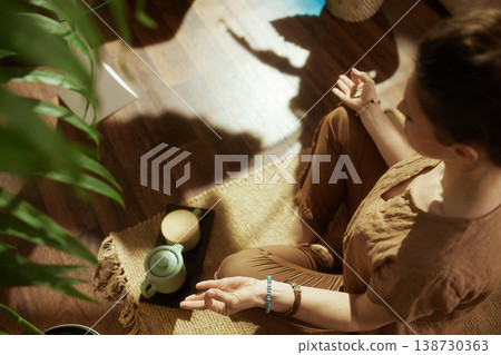 Woman Practicing Mudra Meditation in Peaceful Home Setting 138730363
