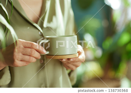Quiet Moment of Reflection with Tea and Greenery Quiet Moment of Reflection with Tea and Greenery 138730368