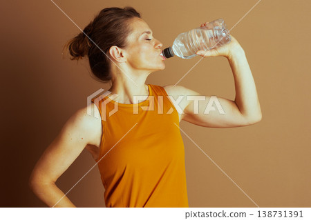 Woman Hydrating, Eyes Closed, Post-Exercise Woman Hydrating, Eyes Closed, Post-Exercise 138731391