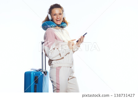 Excited Woman Pointing with Blue Suitcase and Phone Excited Woman Pointing with Blue Suitcase and Phone 138731427