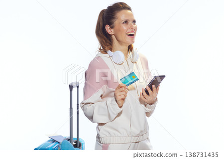 Excited Traveler Dreaming of Vacation with Phone and Credit Card Excited Traveler Dreaming of Vacation with Phone and Credit Card 138731435