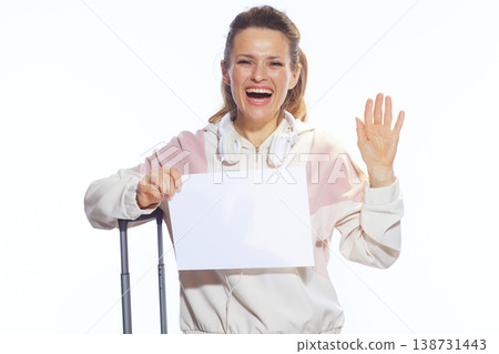 Cheerful Woman Waving with Blank Sign and Suitcase 138731443