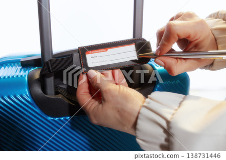 Filling Out a Luggage Identification Tag for Travel 138731446